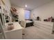 Cozy bedroom with neutral decor and a large window for natural light at 6999 Bard Ave, Las Vegas, NV 89113