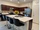 Modern kitchen featuring stainless steel appliances and an island with seating at 6999 Bard Ave, Las Vegas, NV 89113