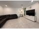 Spacious living room with tile flooring and a comfortable leather sectional at 6999 Bard Ave, Las Vegas, NV 89113