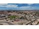 Breathtaking aerial view showcases the community and nearby mountains, featuring lush park with homes and winding paths at 703 Flaming Cliffs Ct, Henderson, NV 89014
