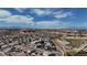 Community aerial shot featuring rows of homes near desert landscape and mountain views on a bright, sunny day at 703 Flaming Cliffs Ct, Henderson, NV 89014