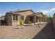 Exterior of home featuring covered patio and low-maintenance gravel landscaping at 703 Flaming Cliffs Ct, Henderson, NV 89014