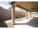 Covered patio with view of gravel landscape and block wall fence at 703 Flaming Cliffs Ct, Henderson, NV 89014