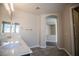 Spacious bathroom with dual sinks, tile flooring, and arched doorway at 703 Flaming Cliffs Ct, Henderson, NV 89014