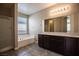 Bright bathroom features dual sinks, soaking tub and glass-enclosed shower at 703 Flaming Cliffs Ct, Henderson, NV 89014
