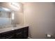 Bathroom with a spacious vanity featuring a marble countertop and dark brown cabinets at 703 Flaming Cliffs Ct, Henderson, NV 89014