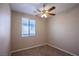 Cozy bedroom with a ceiling fan, neutral walls and window with blinds at 703 Flaming Cliffs Ct, Henderson, NV 89014