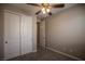 Bedroom features a ceiling fan, carpet, and closet with white sliding doors at 703 Flaming Cliffs Ct, Henderson, NV 89014