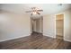 Bedroom with wood-look flooring, adjacent bathroom, and walk-in closet at 703 Flaming Cliffs Ct, Henderson, NV 89014