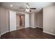 Bedroom with double doors leading to hallway features wood floor and ceiling fan at 703 Flaming Cliffs Ct, Henderson, NV 89014