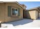 Close up of house with window, green shutters, and textured stucco exterior at 703 Flaming Cliffs Ct, Henderson, NV 89014