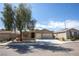 Charming single-story home featuring a two-car garage and a mature shade tree in the front yard at 703 Flaming Cliffs Ct, Henderson, NV 89014