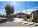 Attractive single-story house with a two-car garage, landscaping and a shade tree at 703 Flaming Cliffs Ct, Henderson, NV 89014