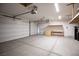 Well lit garage with overhead storage and automatic door at 703 Flaming Cliffs Ct, Henderson, NV 89014