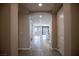 Neutral-toned hallway with views of a kitchen and bedroom at 703 Flaming Cliffs Ct, Henderson, NV 89014