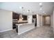 Kitchen features an island with granite countertops and dark cabinets at 703 Flaming Cliffs Ct, Henderson, NV 89014