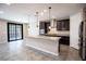 Bright kitchen features an island with granite countertop and dark cabinets at 703 Flaming Cliffs Ct, Henderson, NV 89014