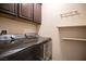 Functional laundry room features modern washer and dryer units and ample storage at 703 Flaming Cliffs Ct, Henderson, NV 89014