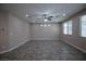 Large living room featuring tile floors, ceiling fan and bright windows at 703 Flaming Cliffs Ct, Henderson, NV 89014
