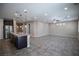 Spacious living room adjoining kitchen features tile floor and ceiling fan at 703 Flaming Cliffs Ct, Henderson, NV 89014