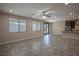 Open-concept living room features neutral tones, tile flooring and a ceiling fan at 703 Flaming Cliffs Ct, Henderson, NV 89014