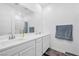Bright bathroom features a double sink vanity, a large framed mirror, tile floor and a walk-in shower at 7364 N Decatur Blvd # 4, Las Vegas, NV 89131