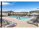 Resort-style community pool with lounge chairs and umbrellas at 7364 N Decatur Blvd # 4, Las Vegas, NV 89131