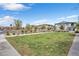 Image features an open grassy community area with trees between the homes and the street at 7364 N Decatur Blvd # 4, Las Vegas, NV 89131