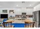 Spacious kitchen island with seating, granite countertops, stainless steel appliances, and white cabinetry at 7364 N Decatur Blvd # 4, Las Vegas, NV 89131