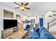 Bright living room with a comfortable blue sofa, open to the kitchen and staircase at 7364 N Decatur Blvd # 4, Las Vegas, NV 89131