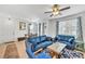 Inviting living room with blue sofas, neutral walls, and coordinated decor, illuminated by a modern ceiling fan at 7364 N Decatur Blvd # 4, Las Vegas, NV 89131