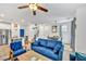 Spacious open-concept living area with modern furnishings, blue sofa, and kitchen in the background at 7364 N Decatur Blvd # 4, Las Vegas, NV 89131