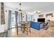 Cozy living area with stylish blue sofa, entertainment unit, dining table, and open floor plan at 7364 N Decatur Blvd # 4, Las Vegas, NV 89131