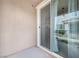 Covered patio area showing the stucco ceiling and walls with the patio door and view of the property at 7364 N Decatur Blvd # 4, Las Vegas, NV 89131