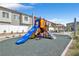 Community playground area for showing a slide, rock climbing and seating with the homes in the background at 7364 N Decatur Blvd # 4, Las Vegas, NV 89131