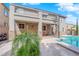 Covered patio overlooks the sparkling pool and lush greenery, perfect for outdoor gatherings at 7715 Villa De La Paz Ave, Las Vegas, NV 89131