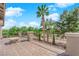 Balcony with stone tile flooring, metal railings, palm tree view, and additional landscaping at 7715 Villa De La Paz Ave, Las Vegas, NV 89131