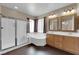 Bathroom featuring shower, soaking tub, double sink vanity, and windows providing ample natural light at 7715 Villa De La Paz Ave, Las Vegas, NV 89131
