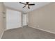 Neutral bedroom featuring carpet, ceiling fan, and closet for ample storage at 7715 Villa De La Paz Ave, Las Vegas, NV 89131