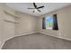 A cozy bedroom featuring neutral walls, carpet, a ceiling fan, and bright natural light from a window at 7715 Villa De La Paz Ave, Las Vegas, NV 89131