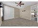 Bedroom featuring carpet, a ceiling fan, and a double door closet for plenty of storage space at 7715 Villa De La Paz Ave, Las Vegas, NV 89131