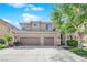 Charming two-story home with a three-car garage and manicured landscaping on a sunny day at 7715 Villa De La Paz Ave, Las Vegas, NV 89131