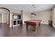 Game room with hardwood floors and a pool table and wall-mounted television at 7715 Villa De La Paz Ave, Las Vegas, NV 89131