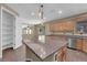 Spacious kitchen features a large island, granite counters, wood cabinets, and stainless appliances at 7715 Villa De La Paz Ave, Las Vegas, NV 89131