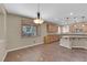 Eat-in kitchen featuring tile floors, wood cabinets, a breakfast bar, and a window at 7715 Villa De La Paz Ave, Las Vegas, NV 89131