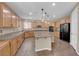 Spacious kitchen features custom cabinets, granite countertops, central island, and stainless steel appliances at 7715 Villa De La Paz Ave, Las Vegas, NV 89131