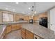 Large kitchen features stainless steel appliances, granite counters, custom cabinets, and a large central island at 7715 Villa De La Paz Ave, Las Vegas, NV 89131