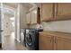Laundry room boasts modern washer and dryer, tile floors and ample storage cabinets at 7715 Villa De La Paz Ave, Las Vegas, NV 89131