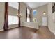 Bright living room with soaring ceilings, wood floors, chandelier, and large windows at 7715 Villa De La Paz Ave, Las Vegas, NV 89131