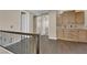 Loft with custom cabinets, dark wood floors, and iron railing overlooking staircase at 7715 Villa De La Paz Ave, Las Vegas, NV 89131